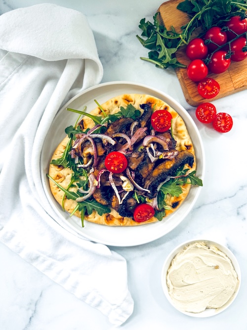 Vegan mushroom shawarma on a pita.
