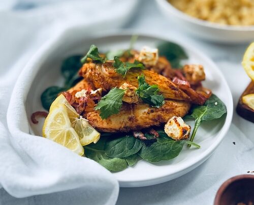 Baked lemon balsamic chicken over spinach,