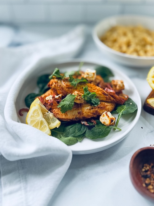 Baked lemon balsamic chicken over spinach,