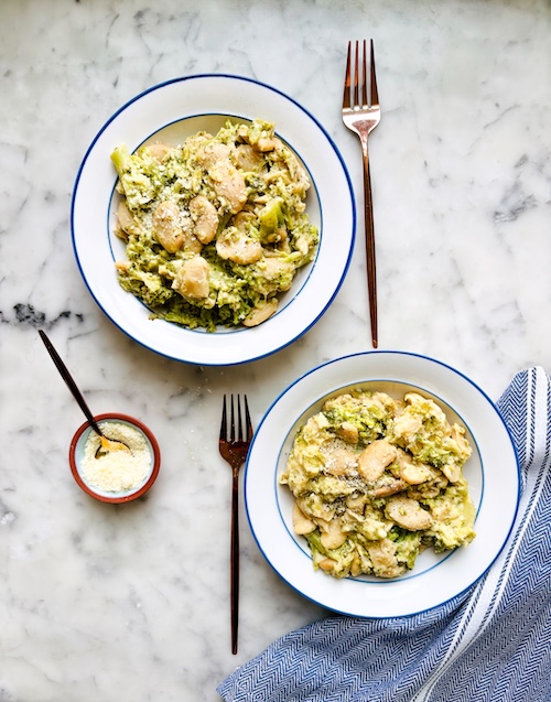 Two bowls of butter bean broccoli Alfredo.