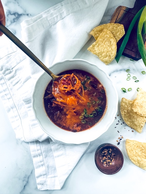 A bowl of cheesy chicken chili.