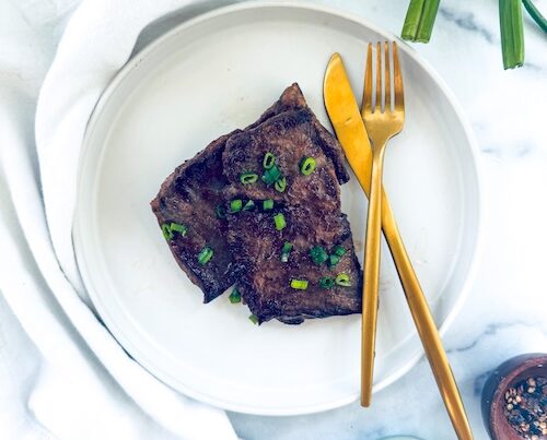 Miso butter skirt steak on a plate.